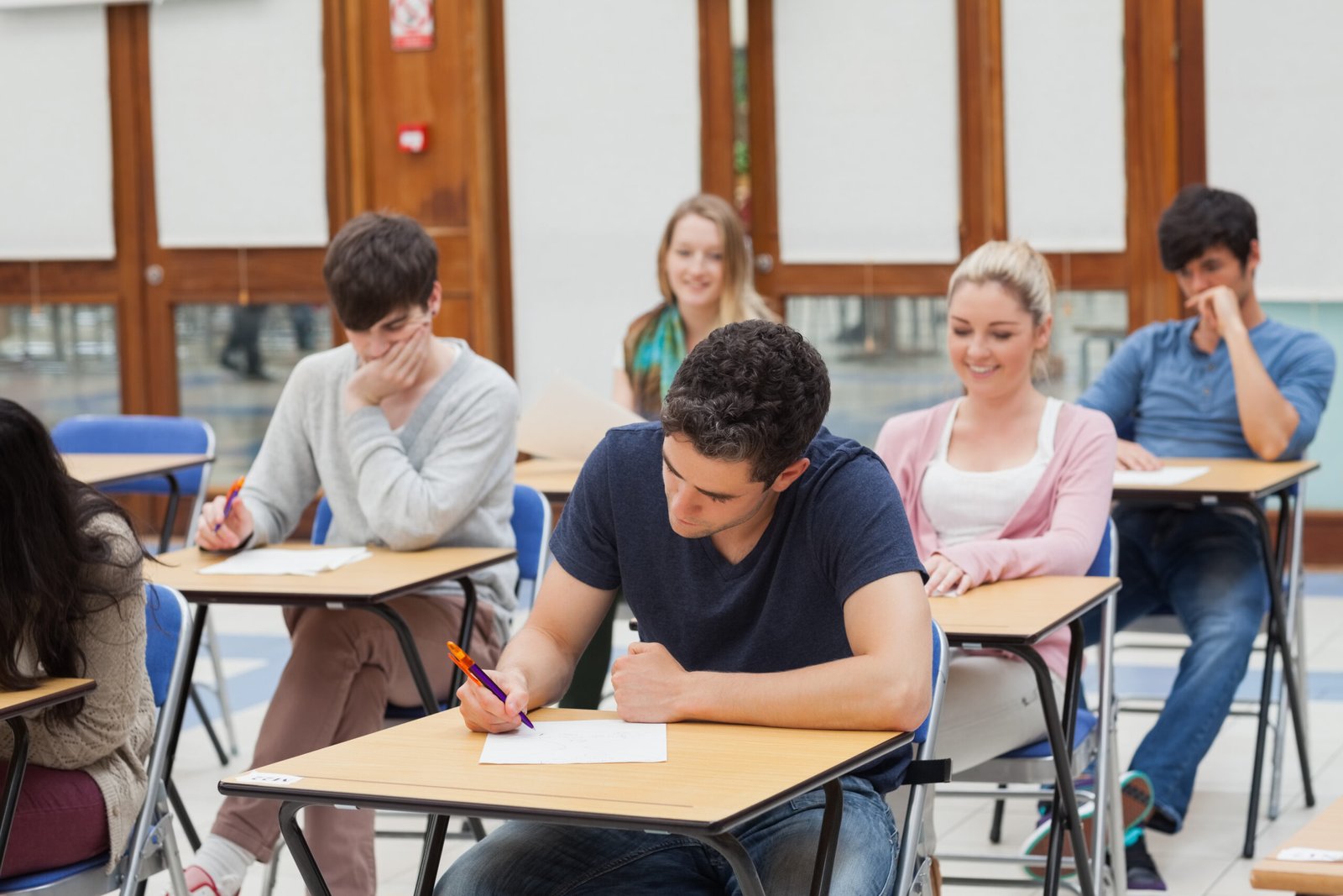 Students sitting at the exam room while writing